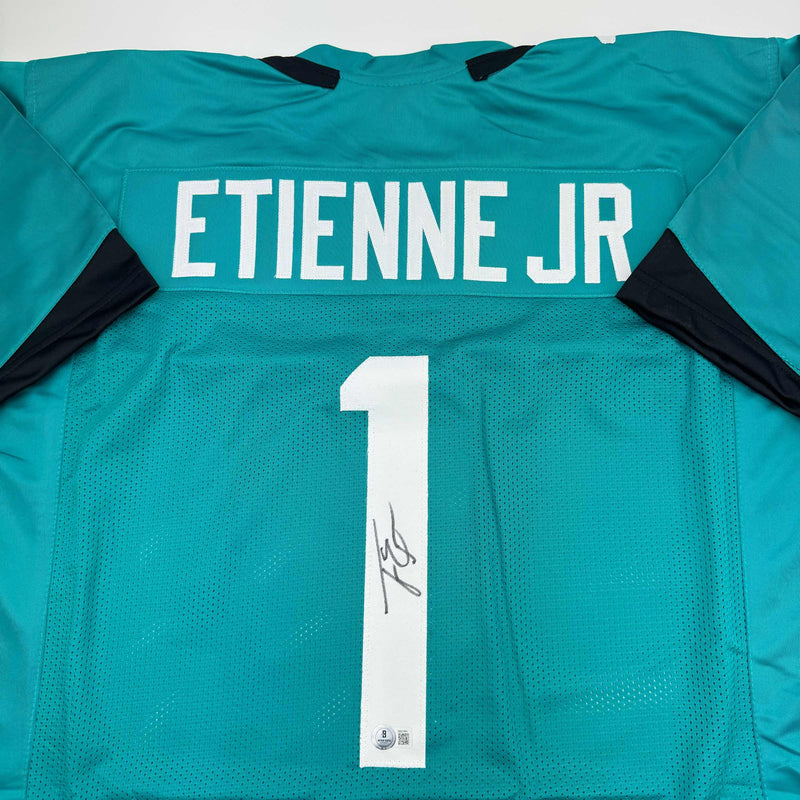 Autographed/Signed Travis Etienne Jr. Jacksonville Teal Football Jersey Beckett BAS COA